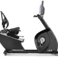 Freemotion r22.9 recumbent exercise bike with black frame, seat console, and pedals on white background