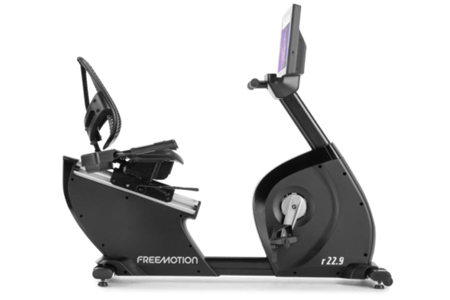 Freemotion r22.9 recumbent exercise bike with black frame, seat console, and pedals on white background