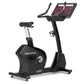 Freemotion u22.9 black upright exercise bike with dual tablet holder and adjustable seat on white background