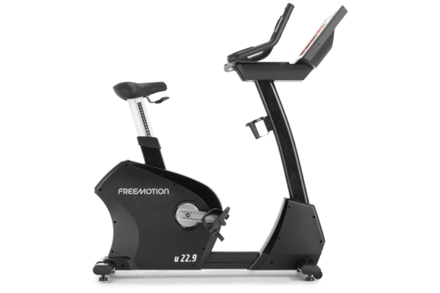 Freemotion u22.9 upright exercise bike with black frame, white seat post, and dual handlebar arms on white background