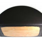 Black molded polyurethane pad with natural wood insert and bolt holes, front view on white background