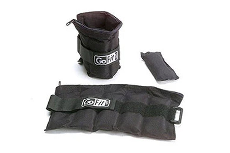 GoFit black adjustable ankle weights set including pair of weighted cuffs with straps and small carrying bag, flat lay on whi
