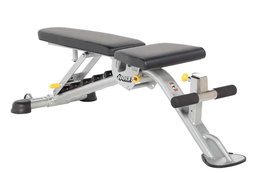 Hoist adjustable weight bench with black padded seat and backrest, silver steel frame, and leg extension attachment on white 
