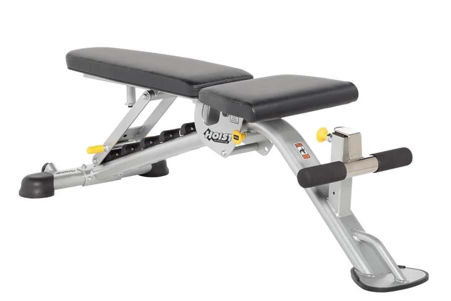 Hoist leg extension and curl bench with black padded seat and backrest, silver metal frame, yellow adjustment knobs, and leg 