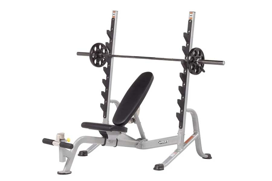 Hoist weight bench with barbell rack, black padded seat, and grey metal frame on white background
