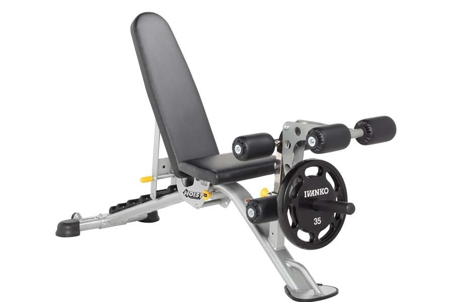 Hoist leg extension and curl machine with black padded seat, silver frame, black wheel weights, and adjustable leg attachment