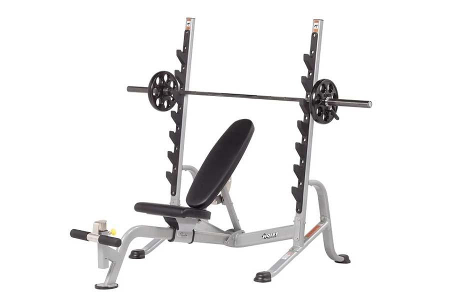 Hoist strength training bench with leg extension and leg curl attachments, silver frame with black padded seat and backrest, 