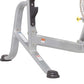 Gray and black leg extension machine base with stabilizing feet and adjustment mechanisms on white background