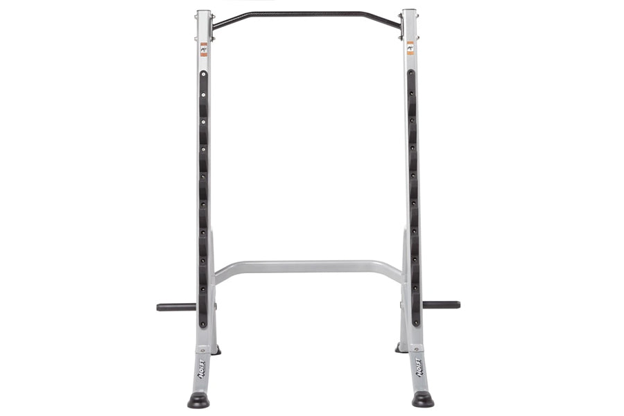 Silver and black multi-purpose squat rack with curved bar, dual uprights, and safety arms on white background