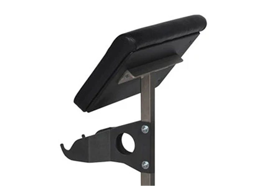 Black padded preacher curl attachment with adjustable arm support and metal mounting bracket on white background