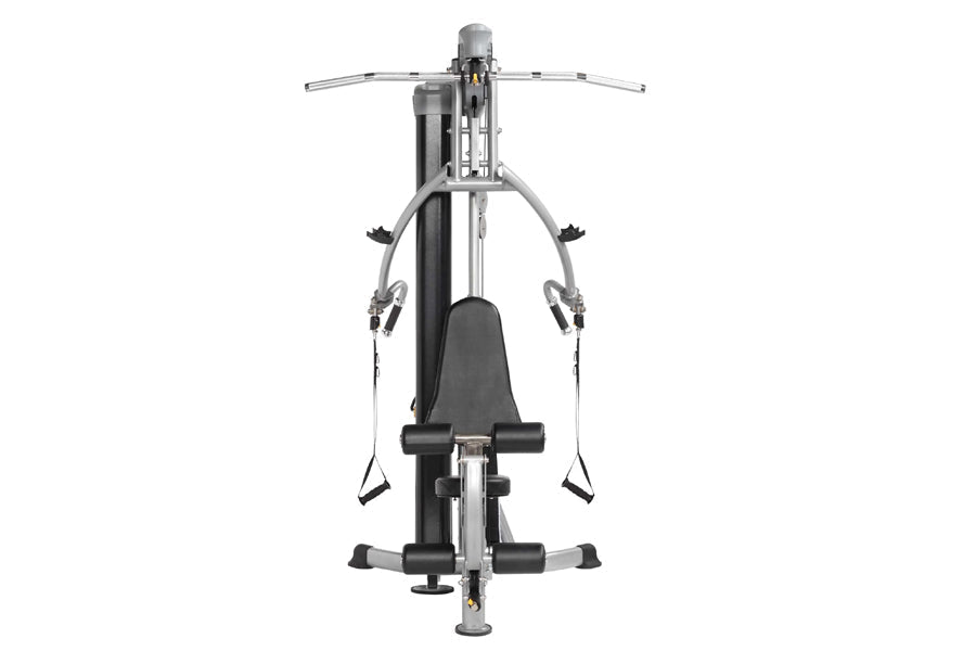 Hoist Mi1 home gym with gray frame, black seat and foot platforms, cable arms, and adjustable handles on white background