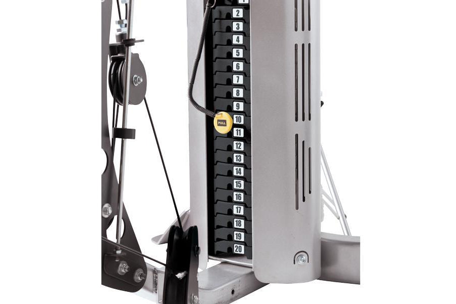 Hoist V4-Elite home gym with numbered black and gold weight stack up to 20, leg press attachment, and cable pulleys on white 