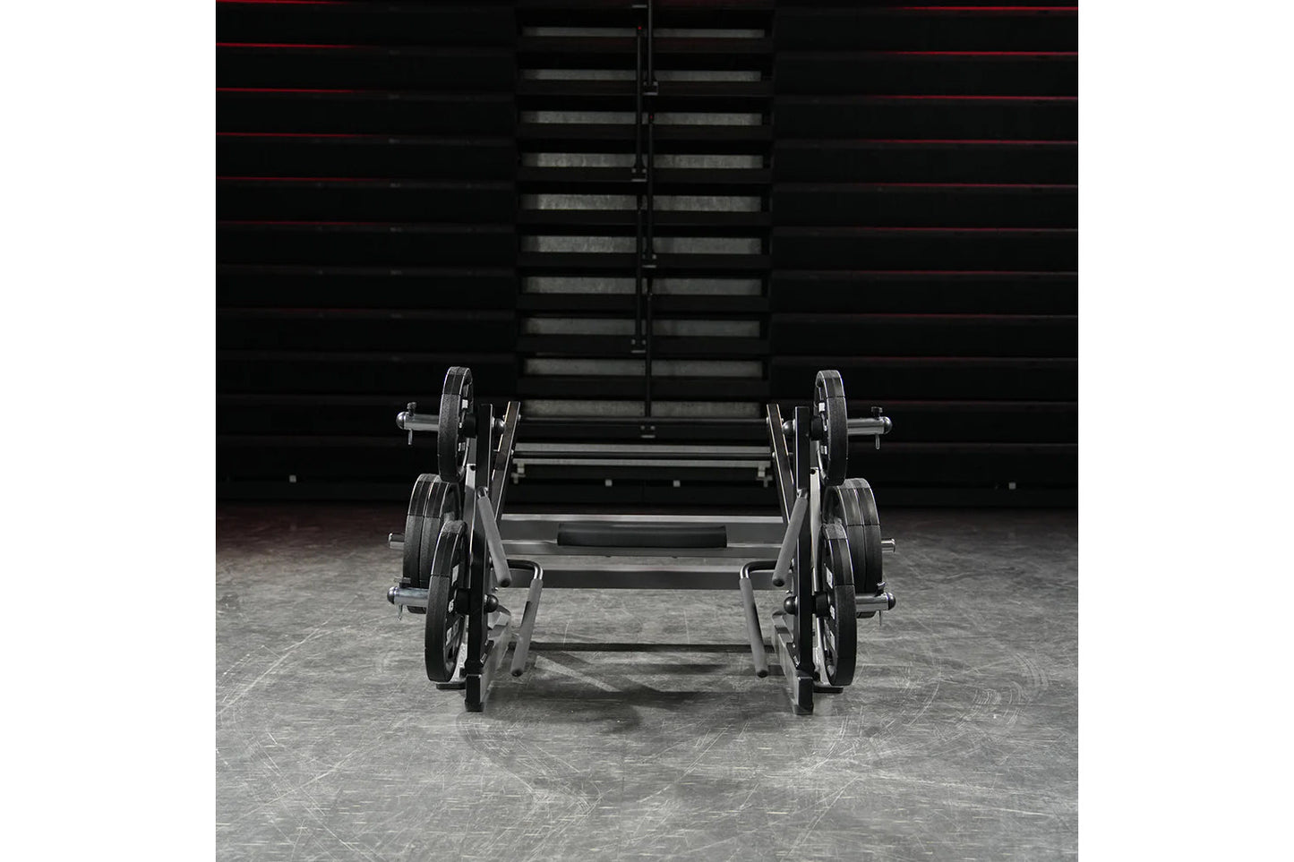 Hammer Strength ground base multi-squat machine with weighted plates and barbell, displayed in gym setting