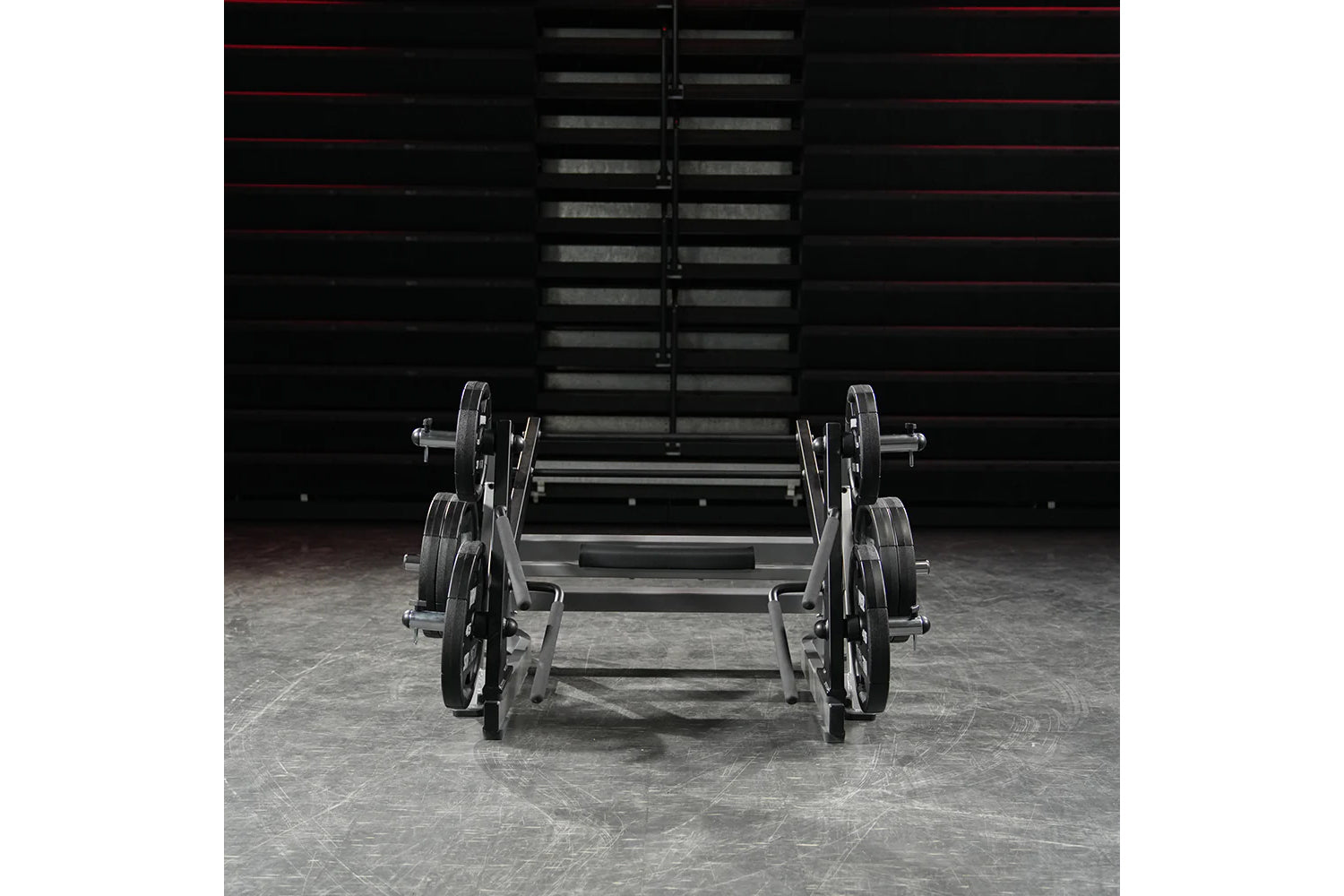 Hammer Strength ground base multi-squat machine with weighted plates and barbell, displayed in gym setting