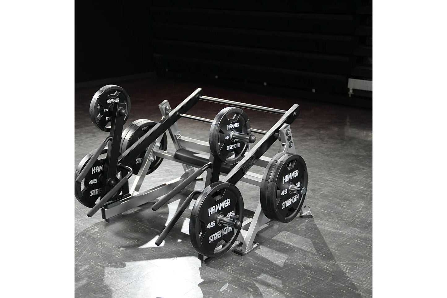 Hammer Strength multi-squat machine with black weight plates and silver metal frame on gym floor