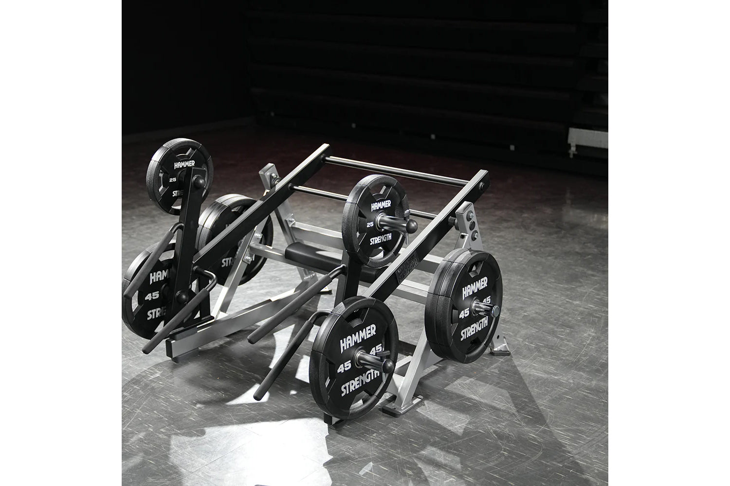 Hammer Strength multi-squat machine with black weight plates and silver metal frame on gym floor