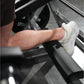 Man wearing white sneaker on Hammer Strength squat machine foot platform, demonstration of proper foot placement