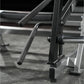 Hammer Strength Ground Base Multi-Squat Machine with black foam handles and chrome bars on gray gymnasium floor