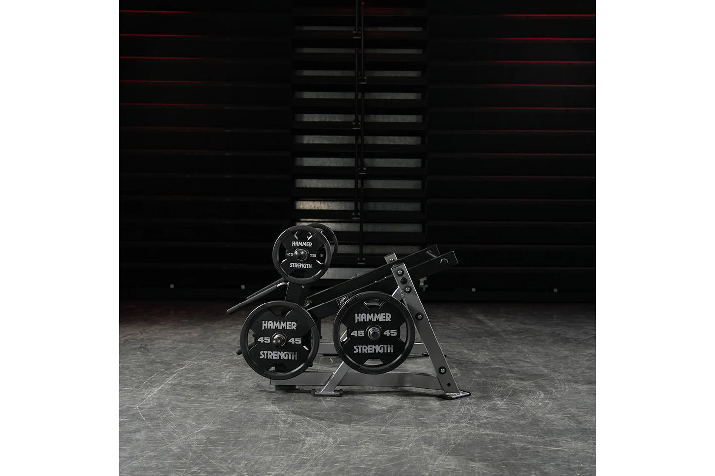 Hammer Strength ground base multi-squat machine with black weight plates and metal frame in gym setting