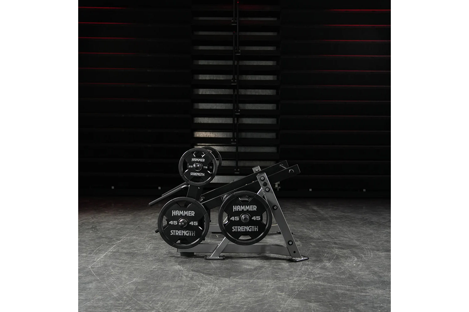 Hammer Strength ground base multi-squat machine with black weight plates and metal frame in gym setting
