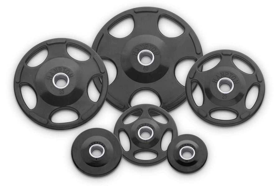 Hampton Olympic grip urethane weight plates in black with chrome center rings, arranged in flat lay on white background