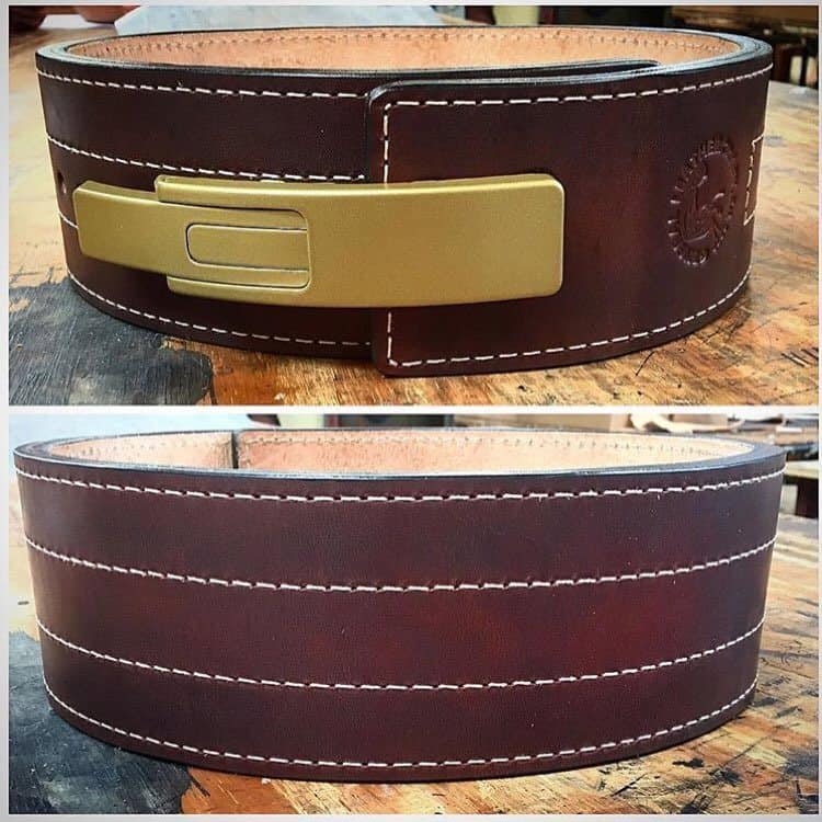 Dark brown leather weightlifting belt with brass lever buckle and white contrast stitching, shown front and back views