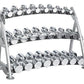 Three-tier gray metal dumbbell rack with chrome saddle holders displaying multiple pairs of chrome dumbbells on white backgro
