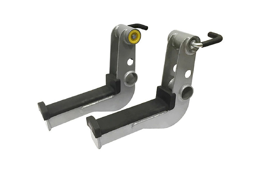 Pair of gray and black metal preacher curl attachments with yellow roller and black handles, flat lay on white background