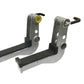 Pair of gray and black metal leg extension attachment brackets with yellow and black adjustment levers, shown on white backgr
