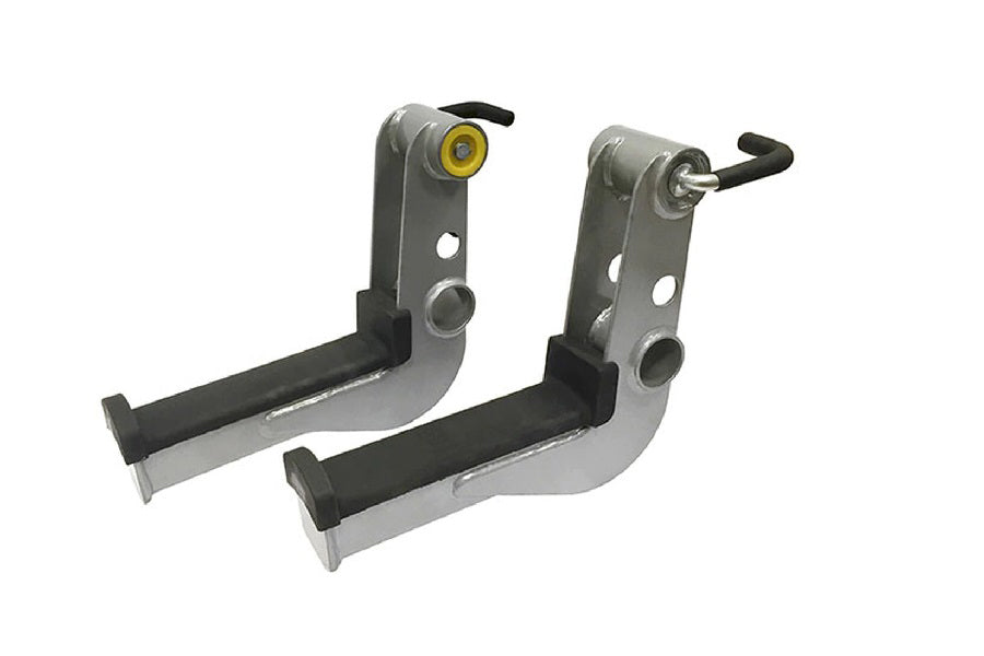Pair of gray and black metal leg extension attachment brackets with yellow and black adjustment levers, shown on white backgr