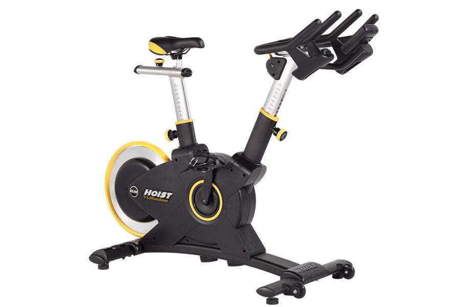 Hoist Lemond Series Elite stationary exercise bike with black frame, yellow accents, and adjustable seat and handlebars
