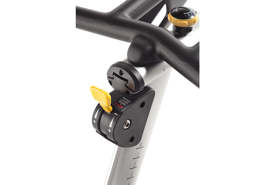 Black and gray stationary bike handlebar with yellow adjustment lever and digital control panel mounted on white stem, close-