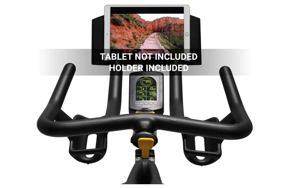 Black stationary bike with curved handlebars, digital console display, and tablet holder mounted on top showing scenic landsc