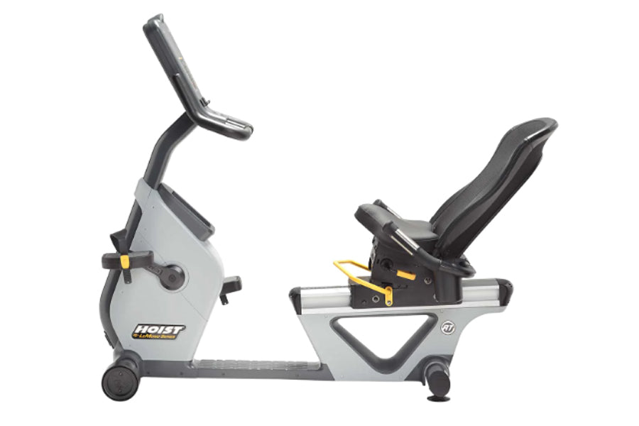 Hoist Lemond RT recumbent exercise bike with white and gray frame, black handlebars, and yellow resistance adjustment lever o