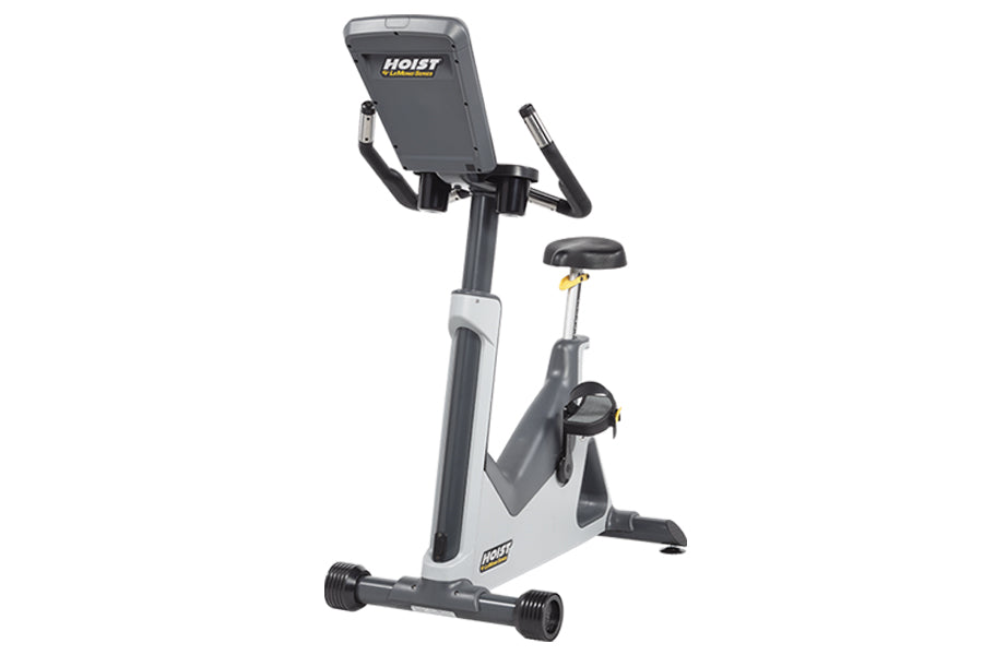 Hoist Lemond Series UC upright exercise bike with gray and white frame, digital console, black seat and handlebars on white b