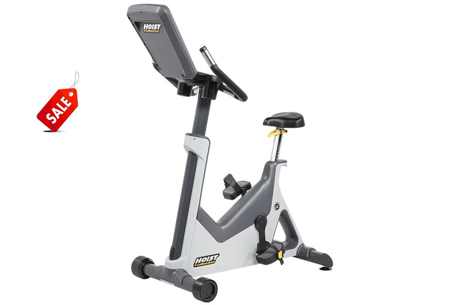 Hoist Lemond Series UC upright exercise bike in white and gray with digital display console and black seat, on white backgrou
