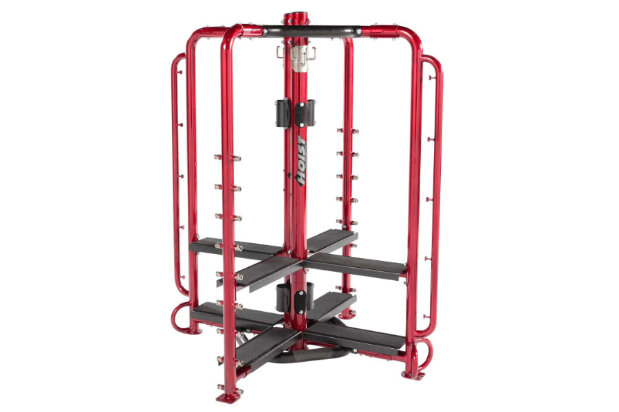 Red and black multi-station exercise machine with dual leg press platforms and cable attachment points on white background