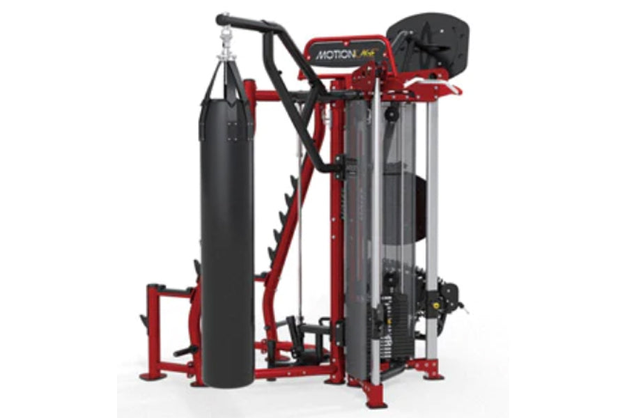 Red and black Hoist MCS-8005 Motioncage multi-station gym equipment with heavy bag, chest press, and leg press stations on wh
