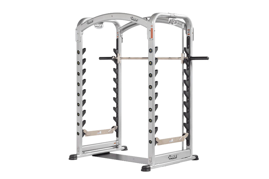 Silver and black dual action Smith machine with adjustable weight pegs, curved top frame, and footrest on white background