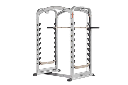 Silver and black dual action Smith machine with adjustable weight pegs, curved top frame, and footrest on white background