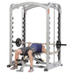 Man using silver and black dual action Smith machine with adjustable barbell on white background