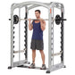 Silver and black dual action Smith machine with male model demonstrating squat position holding barbell