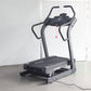 Black and gray motorized treadmill with digital console, curved handrails, and black running belt on white background