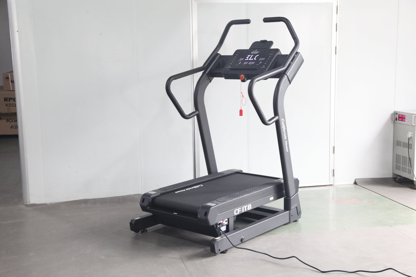 Black and gray motorized treadmill with digital console, curved handrails, and black running belt on white background