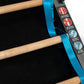 Black and blue Jacob's Ladder climbing machine with wooden rungs and blue safety straps, displayed at angle on gray backgroun