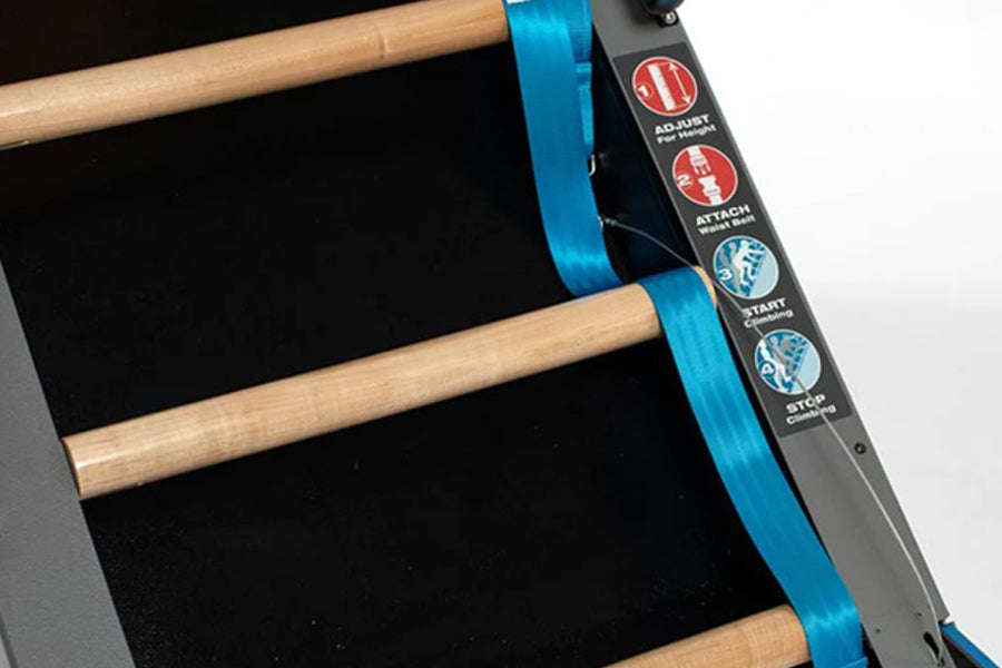 Black and blue Jacob's Ladder climbing machine with wooden rungs and blue safety straps, displayed at angle on gray backgroun
