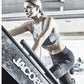 Woman in blue sports bra and black shorts using Jacobs Ladder climbing machine in gym
