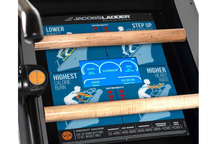 Jacobs Ladder X climbing machine with blue display screen showing workout metrics, wooden rungs, and orange accent details on