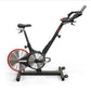 Black and red indoor stationary bike with dual silver flywheels, adjustable seat and handlebars, displayed on white backgroun