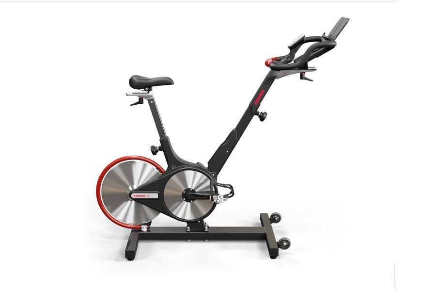 Black and red indoor stationary bike with dual silver flywheels, adjustable seat and handlebars, displayed on white backgroun